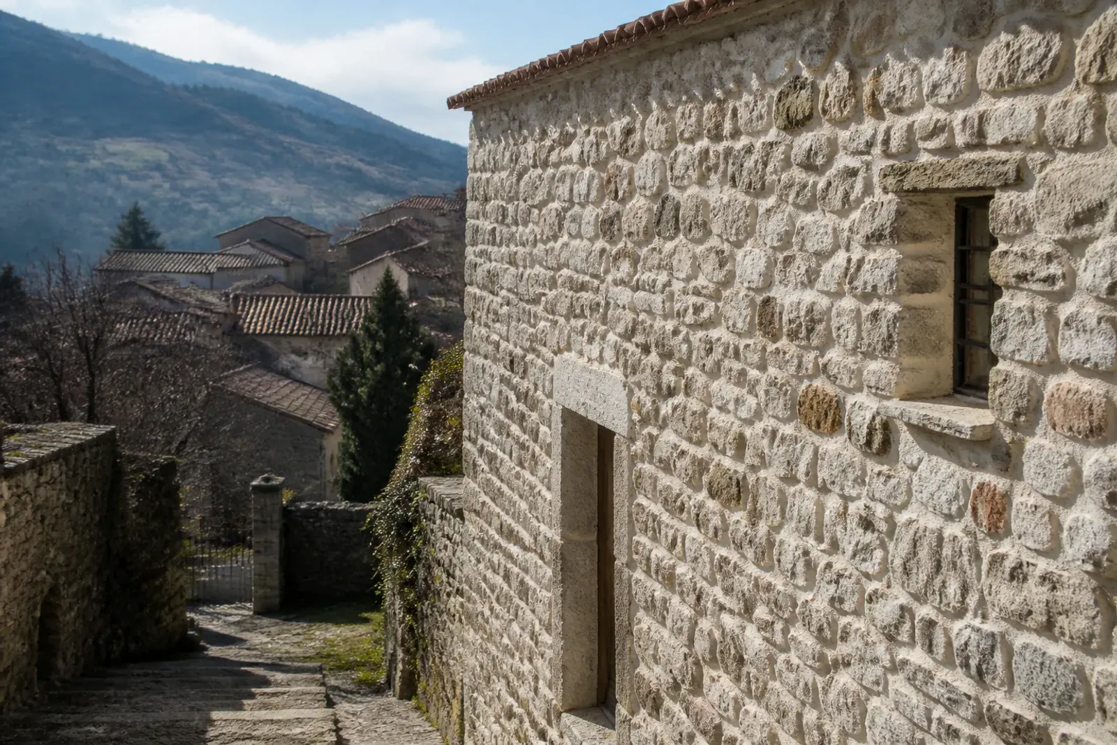 Borgo di collina con case e muri in pietra a vista